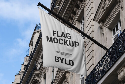 Realistic flag mockup on building exterior perfect for designers to display logos, branding projects, or advertising designs.
