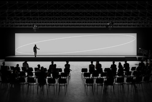 Silhouette of a speaker on stage with audience, modern event mockup, presentation design, keynote template, professional conference.