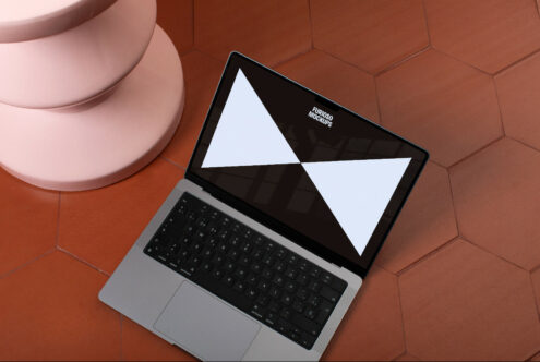 Laptop mockup on terracotta tiles with open screen design template, showcasing digital asset for graphic designers.